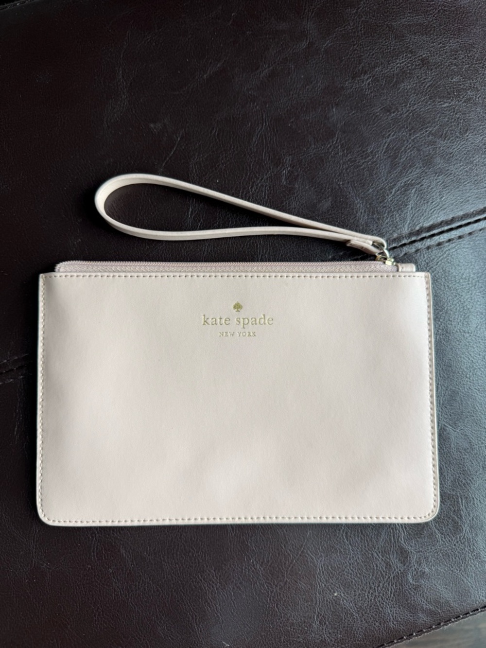 kate spade pale pink wristlet clutch with gold logo